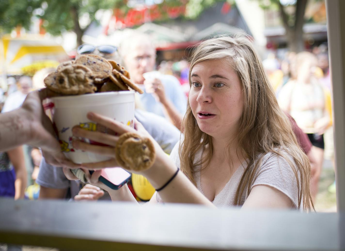 Sweet Martha&#x2019;s Cookies was hopping on the first day of the 2015 Minnesota State Fair. Catherine Guden of Apple Valley took her bucket as (catastrophe!) cookies fell.