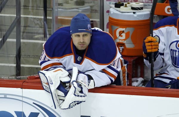 Edmonton Oilers goalie Ilya Bryzgalov, of Russia, watches from the bench during the first period of an NHL hockey game against the Minnesota Wild in S