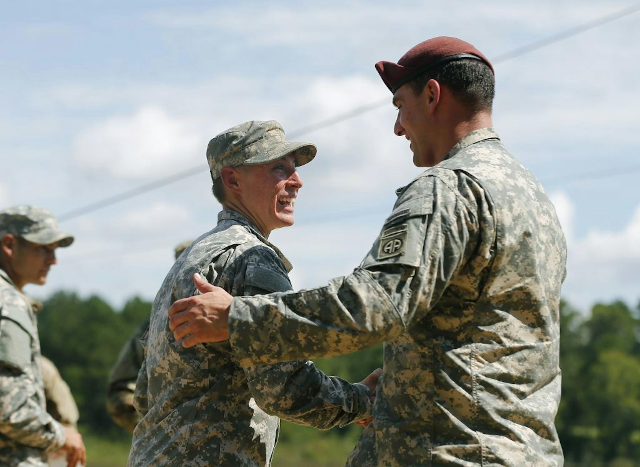 U.S. Army First Lt. Shaye Haver, left, is congratulated by an unidentified soldier before an Army Ranger school graduation ceremony Friday, Aug. 21, 2015, at Fort Benning, Ga. Haver and Capt. Kristen Griest became the first female graduates of the Army's rigorous Ranger School, putting a spotlight on the debate over women in combat.
