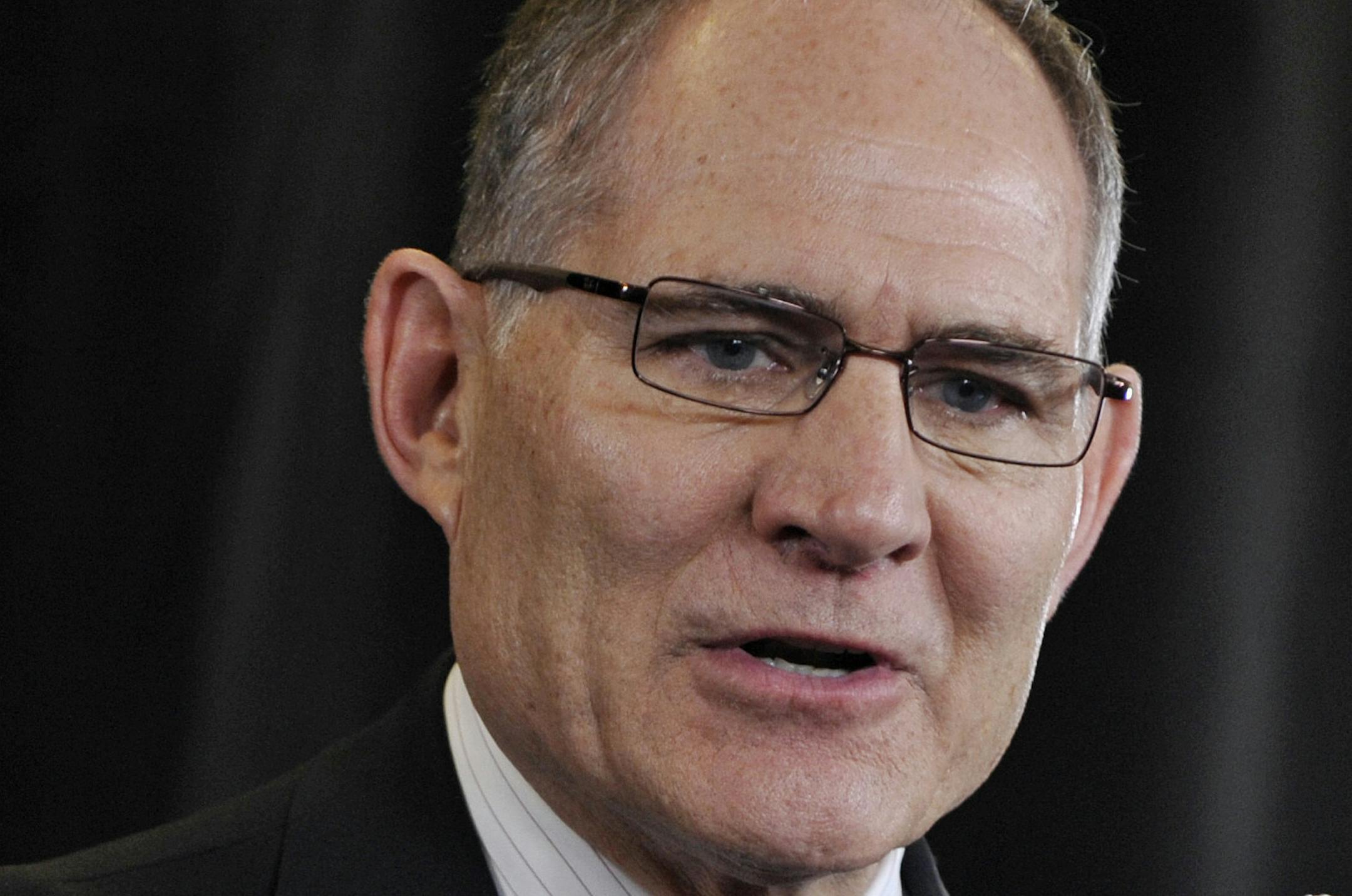 University of Minnesota president Eric Kaler, left, listens as athletic director Joel Maturi, who spent a decade serving the Golden Gophers, addresses the media during news conference announcing his retirement, Thursday, Feb. 2, 2012, in Minneapolis. Maturi will leave his post when his contract expires this summer. (AP Photo/Jim Mone)
