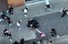 An image from a police drone video shows two teenagers fighting on the ground at the Northtown Mall carnival as an officer intervenes to try and break