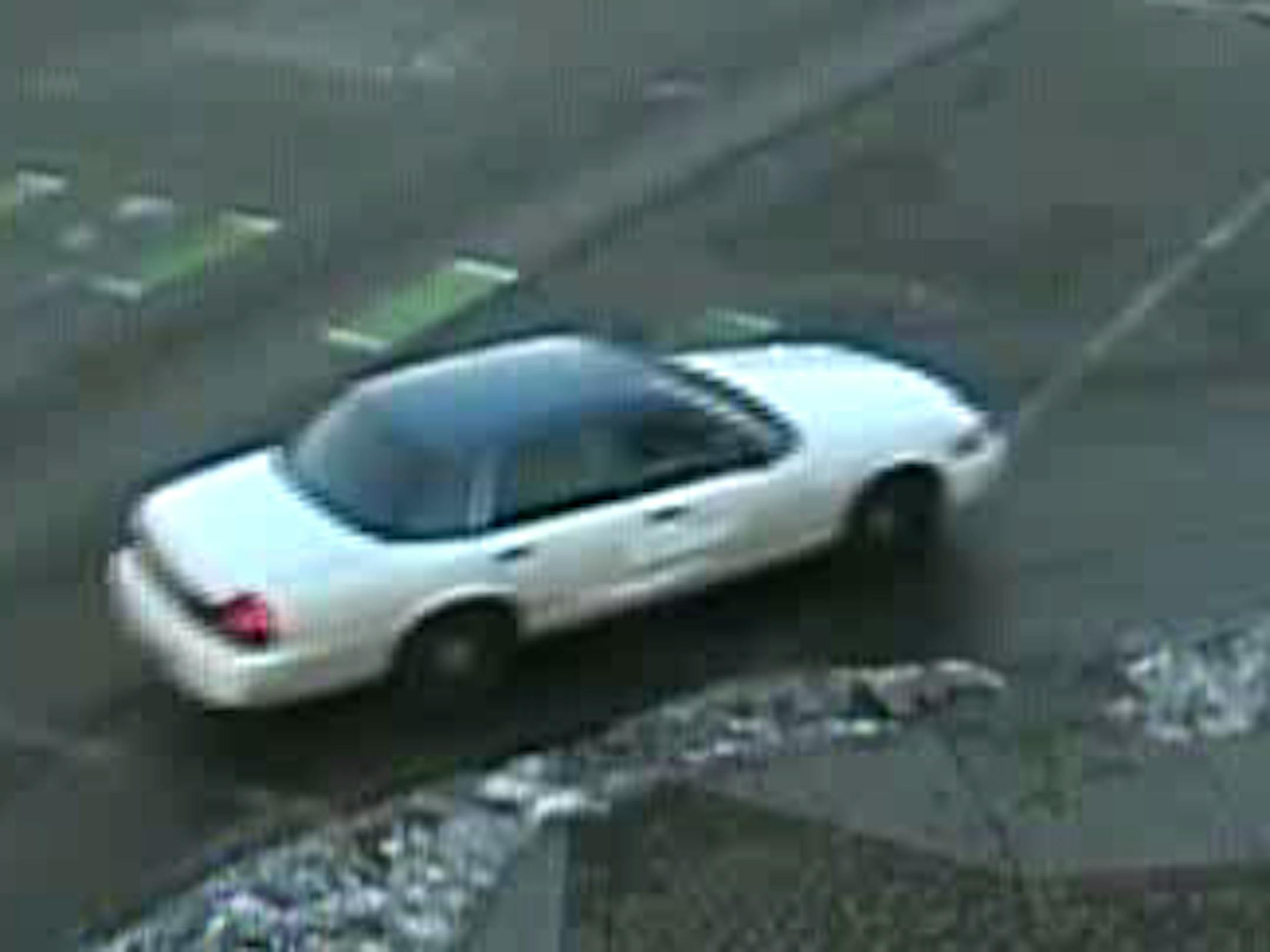 Witnesses described the vehicle as an older model Ford Crown Victoria, white in color with possibly a dark roof. It was described as possibly having been a taxi previously.