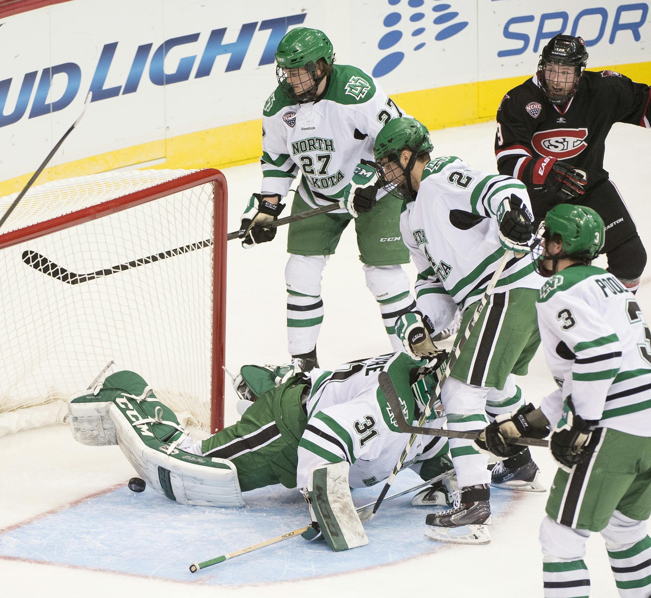 St. Cloud State left wing Joey Benik (9), top right, reacts as he sees his shot make it past North Dakota goalie Zane McIntyre with five seconds left in the first period. ] (Aaron Lavinsky | StarTribune) #18 St. Cloud State plays #1 North Dakota in a NCHC semifinal game on Friday, March 20, 2015 at Target Center.