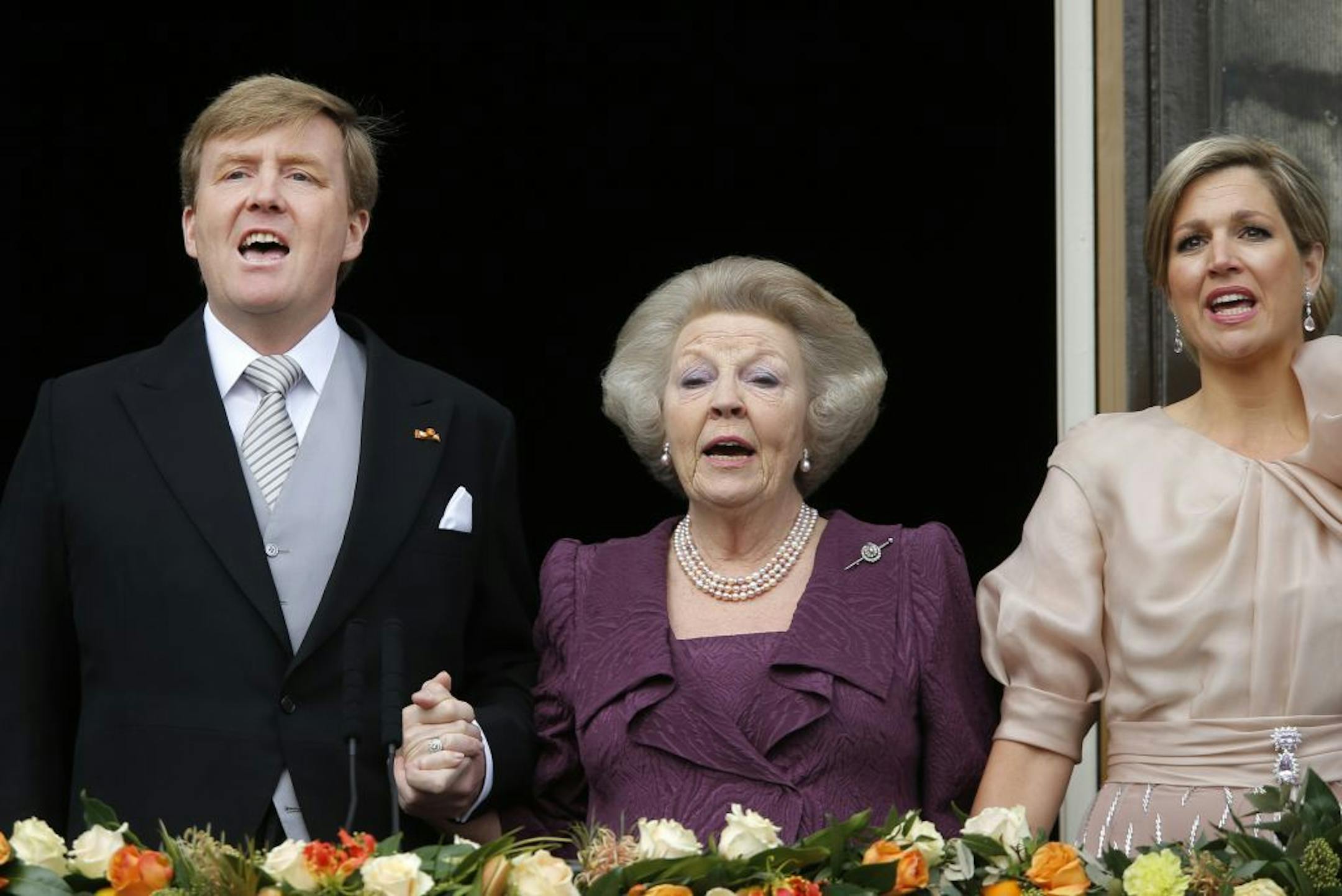 Dutch King Willem-Alexander, Queen Maxima, right, and Princess Beatrix sing the Dutch national anthem from the balcony of the Royal Palace in Amsterdam, The Netherlands, Tuesday April 30, 2013. Around a million people are expected to descend on the Dutch capital for a huge street party to celebrate the first new Dutch monarch in 33 years.