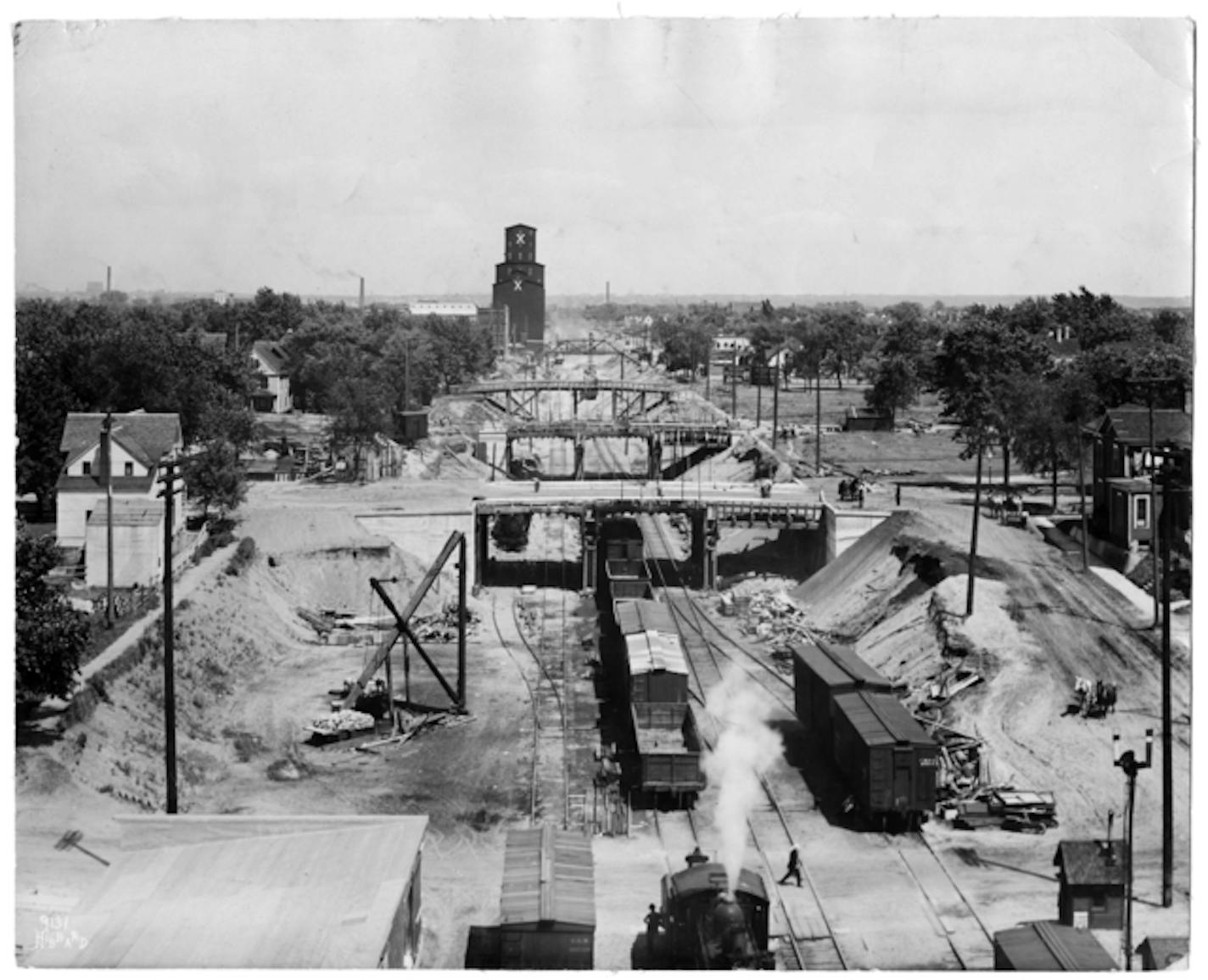 Looking west from Fourth Avenue South at the bridges built over the railroad tracks in Minneapolis in what is now the Midtown Greenway. Photo from 1915, courtesy of the Minnesota Historical Society. ORG XMIT: Documentation