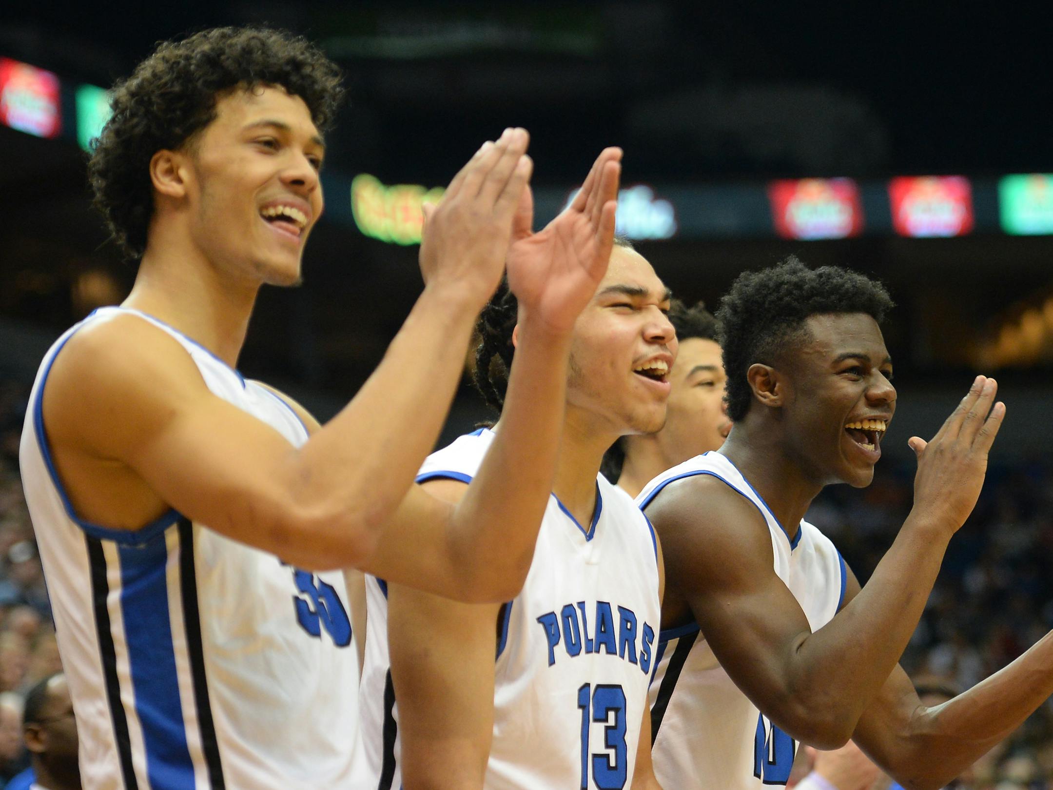 Minneapolis North players, including guard Isaac Johnson (35), guard Pat Dembley (13) and guard Tyler Johnson (10) cheered for their players off the bench in the final minute of Saturday's 1A championship game against Goodhue. ] (AARON LAVINSKY/STAR TRIBUNE) aaron.lavinsky@startribune.com Minneapolis North played Goodhue in the Class 1A boys’ basketball championship game on Saturday, March 12, 2016 at Target Center in Minneapolis, Minn.
