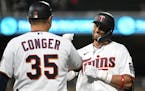 Minnesota Twins shortstop Royce Lewis (23) celebrates his first base hit with first base coach Hank Conger (35) in the bottom of the 8th inning.