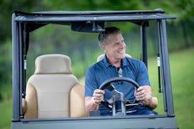 KARE 11's Randy Shaver tests a golf cart that was being given away during his June golf fundraiser in Maple Grove. Shaver retires this month after fou