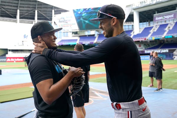Miami Marlins second baseman Luis Arraez, left, talks with Minnesota Twins shortstop Carlos Correa before a baseball game, Monday, April 3, 2023, in M