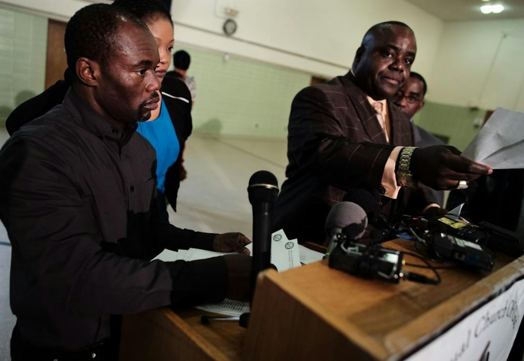 Pastor Harding Smith, who has been representing Barway Collins' family conducted a press conference today regarding recent allegations about the father taking out life insurance on the boy. Pierre Collins, far left, the father of Barway was present his family.