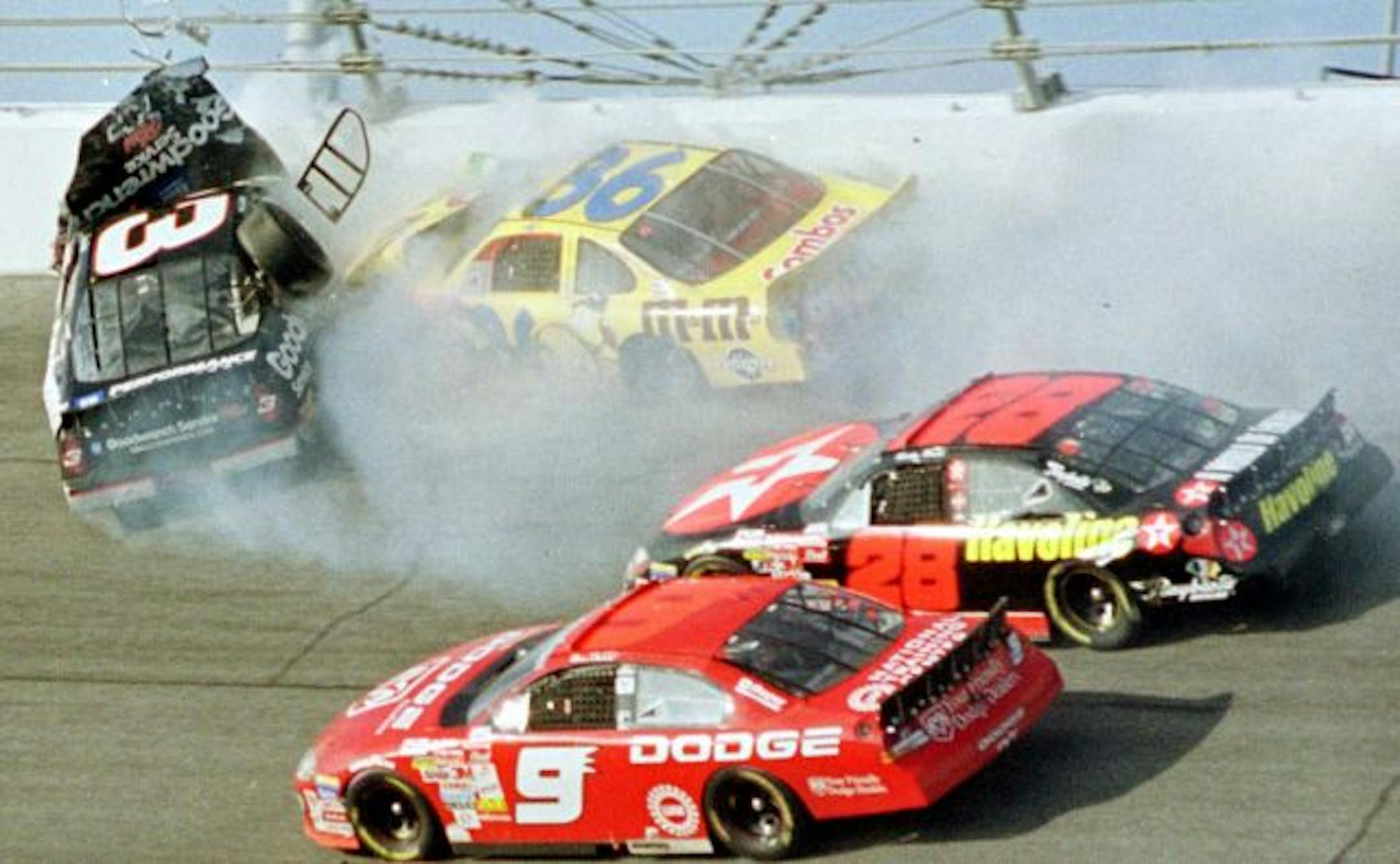 A photo taken Feb. 18, 2001, showed the window of Dale Earnhardt's No. 3 popped out after the car was hit by Ken Schrader (36) during the Daytona 500 . Bill Elliott (9) and Ricky Rudd (28) bypassed what became the scene of Earnhardt's death.