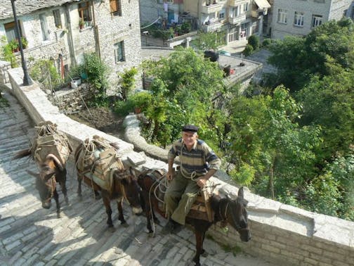The view from the window at the Kotoni House, a B&B in Gjirokastra, Albania. Gjirokastra is a UNESCO World Heritage Site with an ancient castle and preserved Ottoman-era stone houses perched above a river valley.