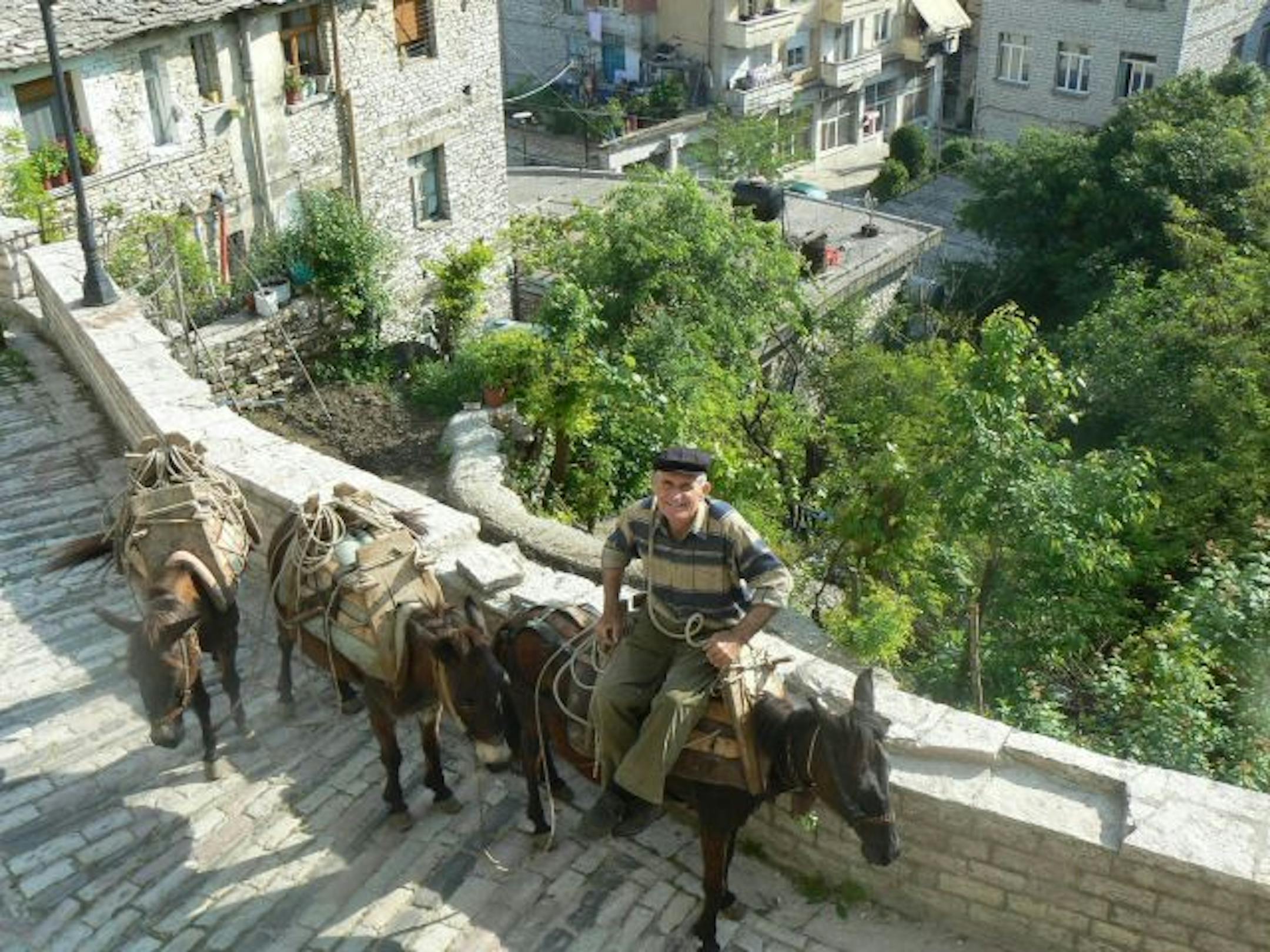 The view from the window at the Kotoni House, a B&B in Gjirokastra, Albania. Gjirokastra is a UNESCO World Heritage Site with an ancient castle and preserved Ottoman-era stone houses perched above a river valley.