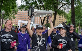 Frost players Taylor Heise, left, Brooke Bryant, and Mellissa Channel-Watkins celebrate the teams PWHL Walter Cup Championship during a parade in down