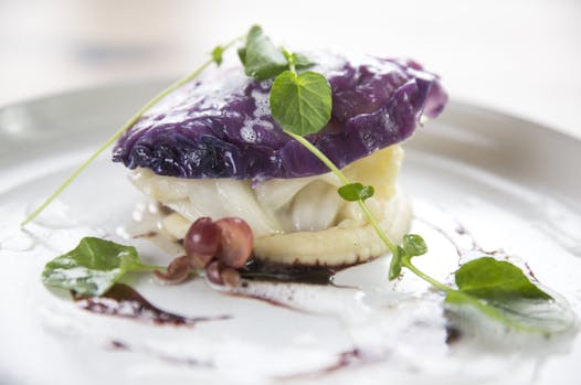 Roasted cod with pickled grapes and butter-poached cabbage.