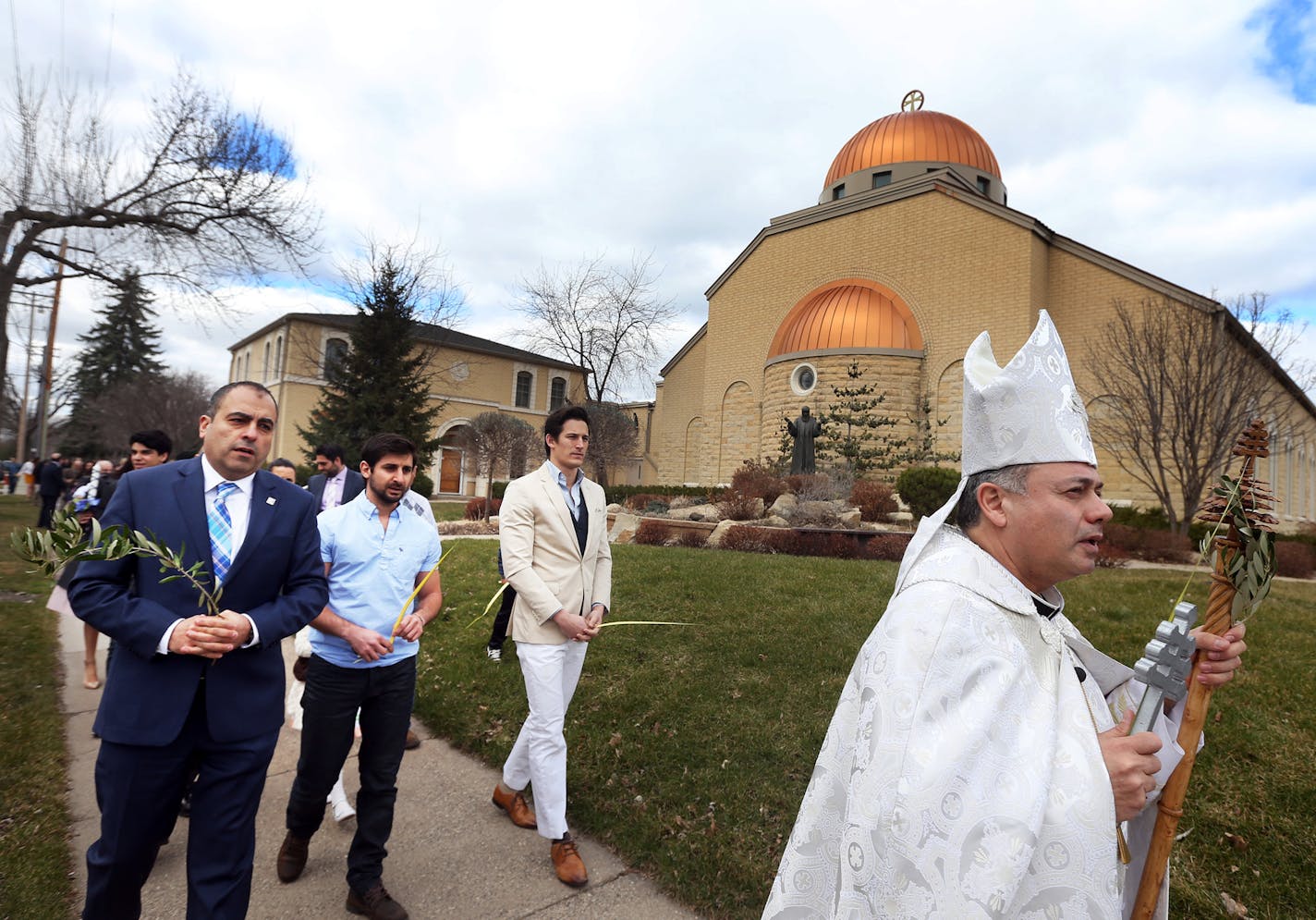 Pastor Sharbel Maroun led a procession around the church after Palm Sunday at St. Maron's Catholic Church in Minneapolis.