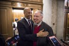 Sens. Cory Booker (D-N.J.) and Chuck Grassley (R-Iowa) embrace after the Senate passed a bipartisan criminal justice reform bill, on Capitol Hill in W
