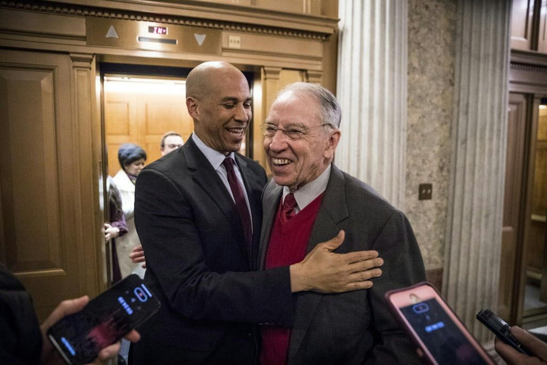 Sens. Cory Booker (D-N.J.) and Chuck Grassley (R-Iowa) embrace after the Senate passed a bipartisan criminal justice reform bill, on Capitol Hill in Washington, Dec. 18, 2018. The Senate overwhelmingly approved on Tuesday the most substantial changes in a generation to the tough-on-crime prison and sentencing laws that ballooned the federal prison population and created a criminal justice system that many conservatives and liberals view as costly and unfair.