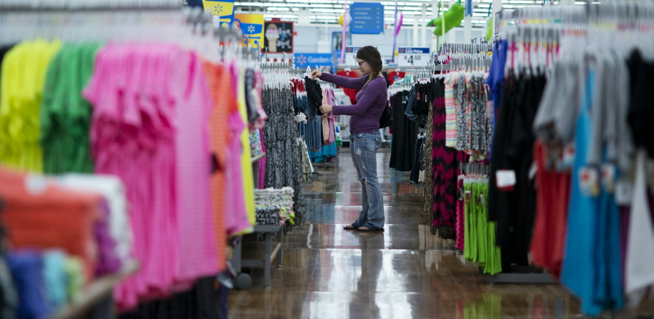 In this June 5, 2014 photo, Chelsea Vick shops for clothes at Wal-Mart Supercenter in Rogers, Ark. The Commerce Department releases retail sales data for May on Thursday, June 12, 2014. (AP Photo/Sarah Bentham)