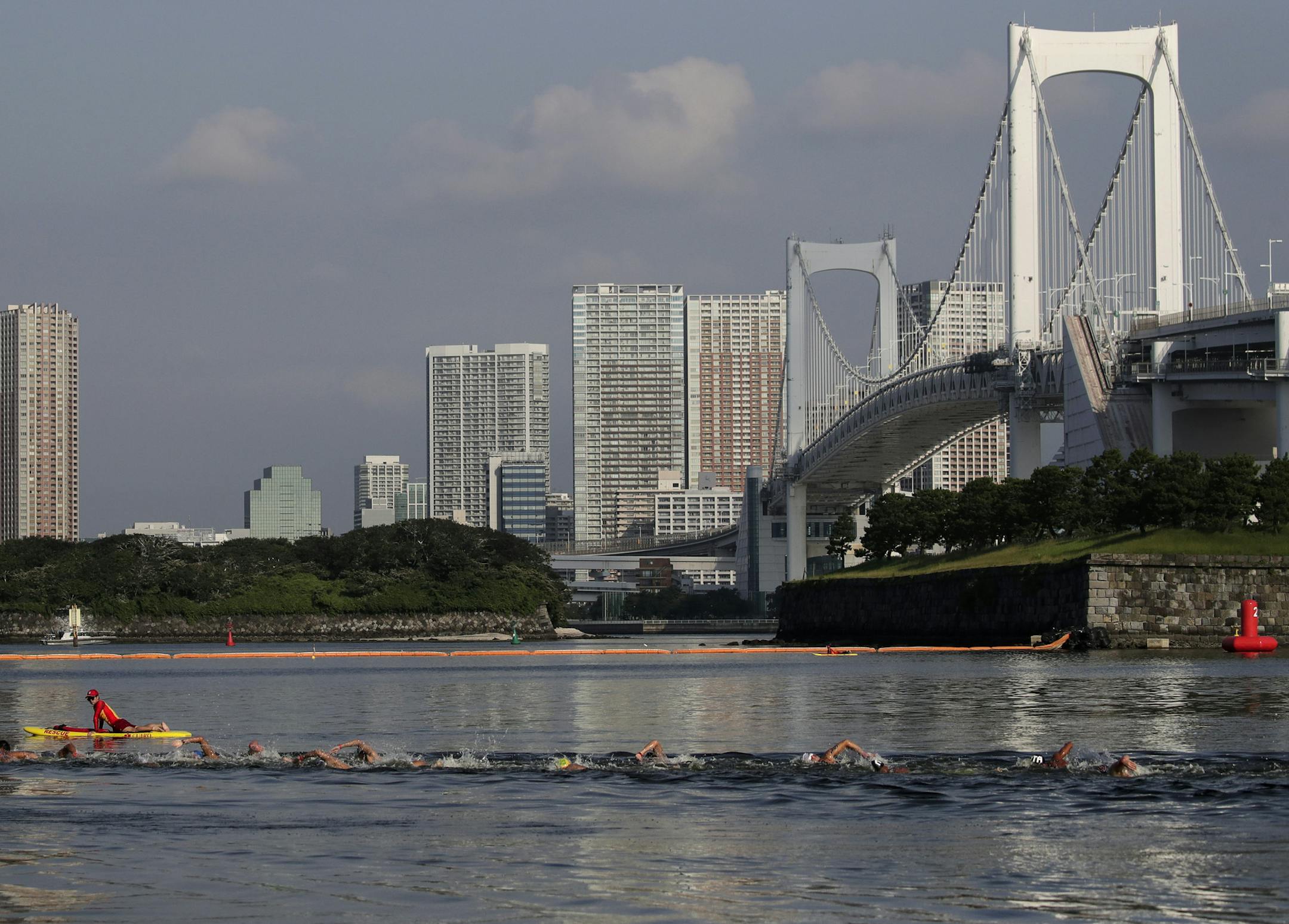 Athletes compete in a marathon swimming test event at Odaiba Marine Park, a venue for marathon swimming and triathlon at the Tokyo 2020 Olympics, Sunday, Aug. 11, 2019, in Tokyo. (AP Photo/Jae C. Hong)