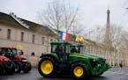Farmers drive their tractors, Friday, Feb. 23, 2024 in Paris. Angry farmers were back to Paris on their tractors in a new protest demanding more gover
