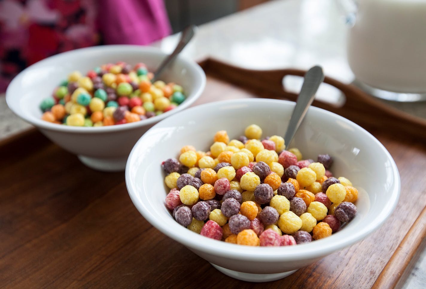 A bowl of the new Trix cereal recipe, right, does not contain the colors blue and green like the former Trix because the bold colors were too difficult to recreate from natural sources. The cereals were photographed in the Betty Crocker Kitchens of General Mills Headquarters in Golden Valley June 11, 2015. General Mills is removing artificial flavors and colors from artificial sources from its cereals. (Courtney Perry/Special to the Star Tribune) ORG XMIT: MIN1506121027500963