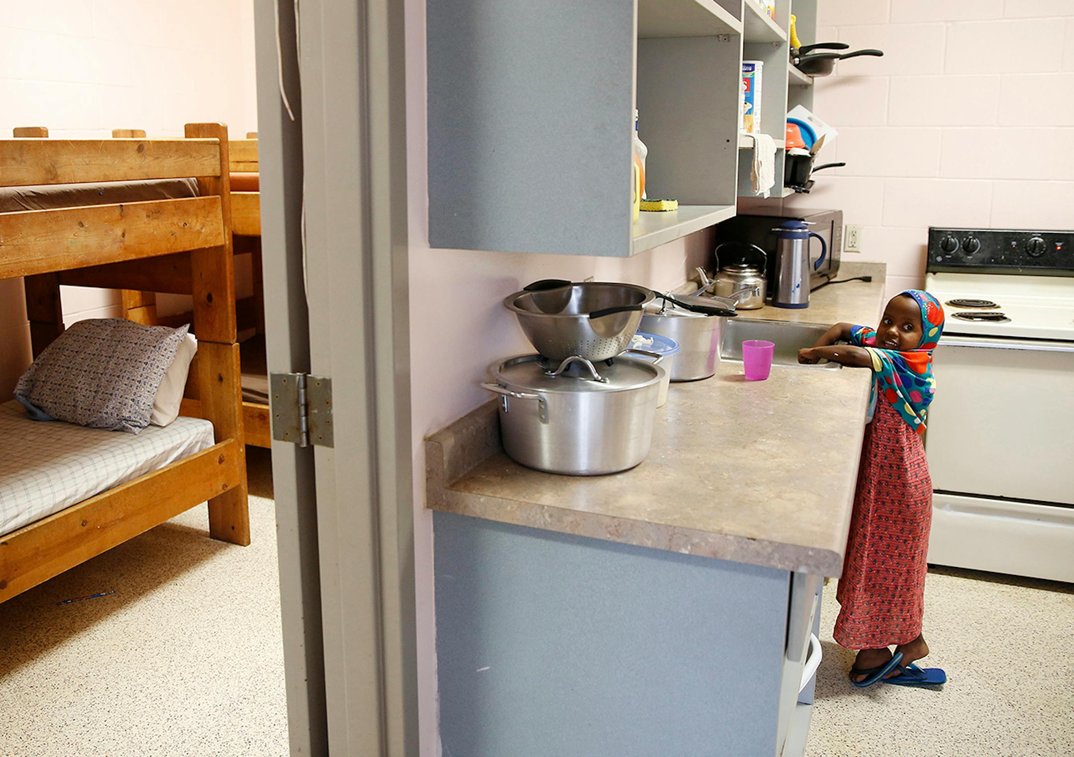 Recent immigrant Hafifa Shukri, 4, washes her hands at her home, Mary's Place transitional apartments in downtown Minneapolis. ] LEILA NAVIDI leila.navidi@startribune.com / BACKGROUND INFORMATION: Tuesday, October 28, 2014. Minnesota has seen a marked uptick in new Somali refugee arrivals recently. The number of Somalis arriving directly from Africa has more than tripled in four years. But community leaders say there's also been an increase in so-called secondary arrivals: refugees resettled in