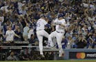 Los Angeles Dodgers' Joc Pederson celebrates his home run with third base coach Chris Woodward during the seventh inning of Game 6 of baseball's World