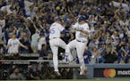 Los Angeles Dodgers' Joc Pederson celebrates his home run with third base coach Chris Woodward during the seventh inning of Game 6 of baseball's World