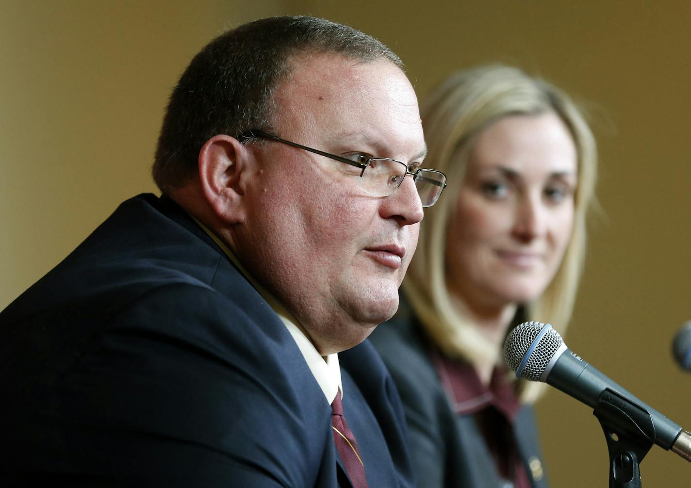 Newly named University of Minnesota head football coach Tracy Claeys, left, addresses a question as interim athletic director Beth Goetz listens during a news conference Wednesday, Nov. 11, 2015, in Minneapolis. Claeys has served as interim head coach after the sudden retirement announcement by former head coach Jerry Kill. (AP Photo/Jim Mone)