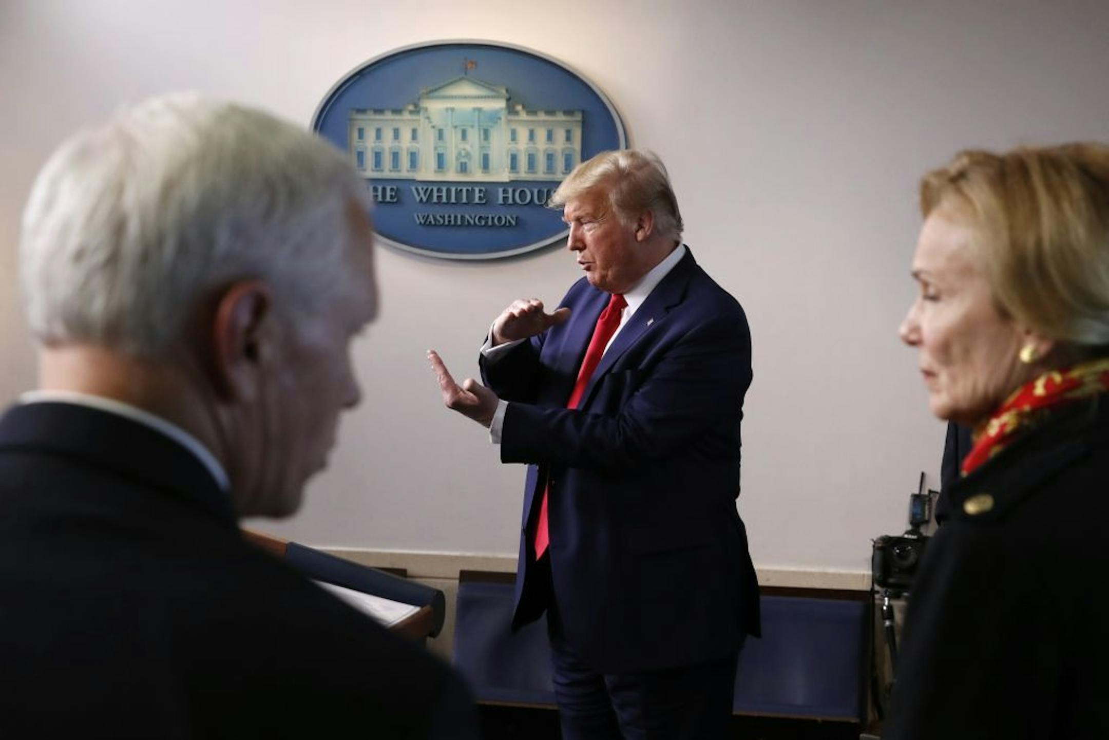 President Donald Trump speaks about the coronavirus in the James Brady Press Briefing Room of the White House, Tuesday, March 31, 2020, in Washington, as Vice President Mike Pence and Dr. Deborah Birx, White House coronavirus response coordinator, listen.