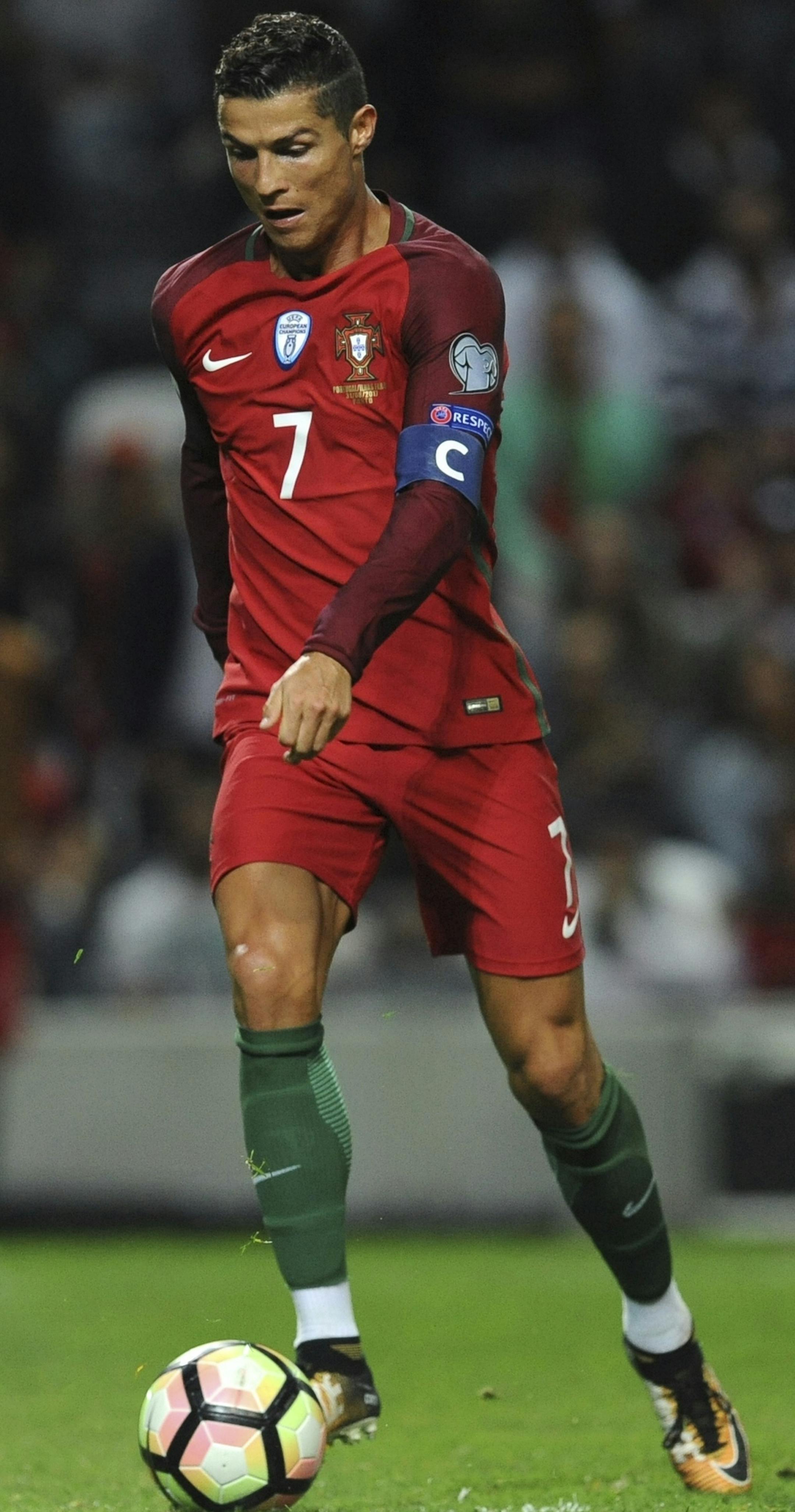 FILE - In this Thursday Aug. 31, 2017 filer, Portugal's Cristiano Ronaldo scores his side's fourth goal during the World Cup Group B qualifying soccer match between Portugal and Faroe Islands at the Bessa Stadium in Porto, Portugal. (AP Photo/Paulo Duarte, File) ORG XMIT: FP124