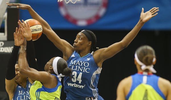 Minnesota Lynx center Sylvia Fowles (34) gets a piece of the ball as Dallas Wings forward Karima Christmas (13) drives to the basket. ] Timothy Nwachu