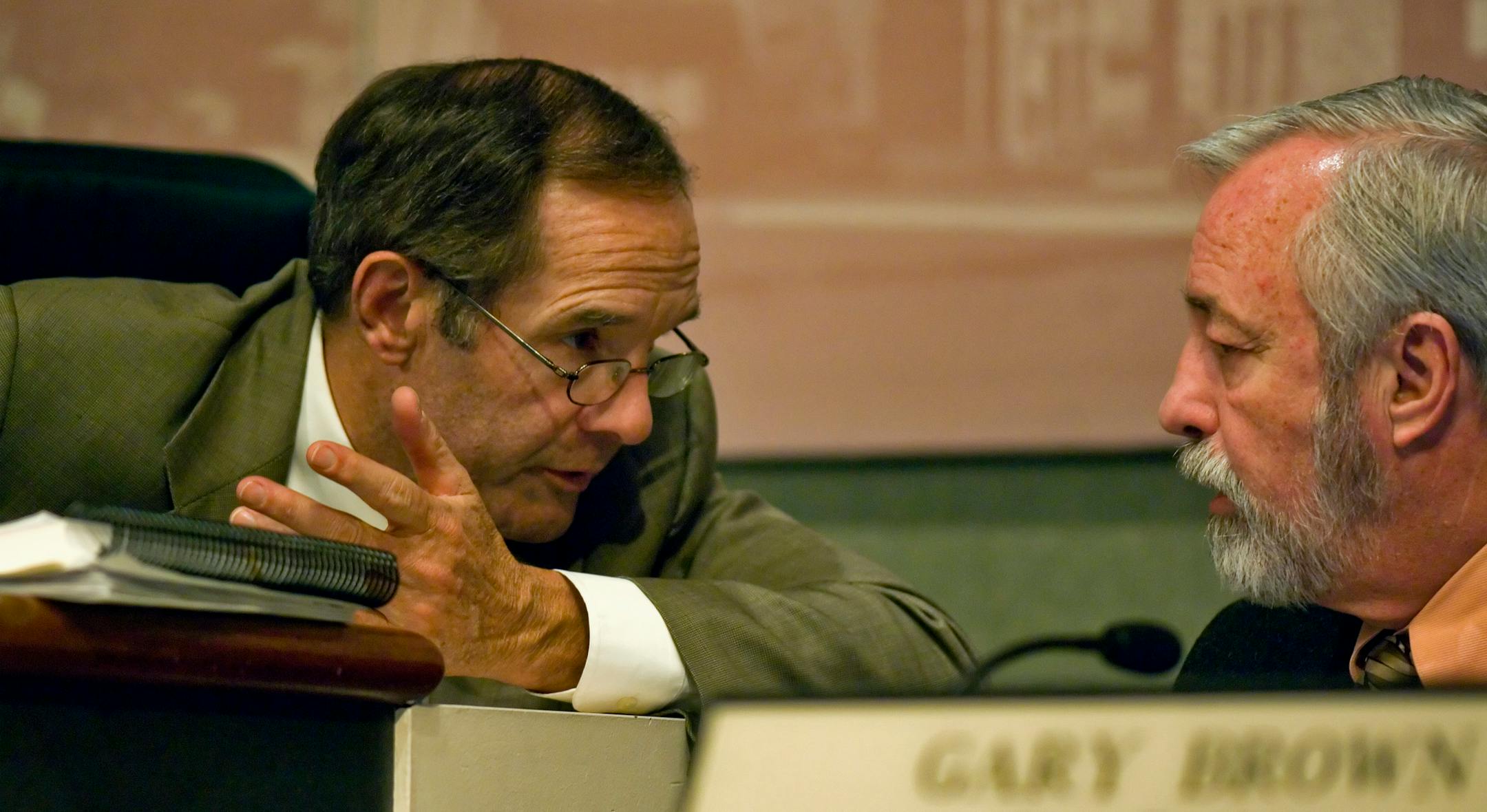 Brooklyn Park City Manager Doug Reeder, left, spoke with City Engineer Gary Brown during a City Council meeting Monday night. As the baby boom generation begins to hit retirement age, municipalities across the state are faced with the problem of replacing them in the workforce.