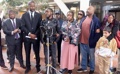 Surrounded by lawyers and family, Ricky Cobb’s twin brother Rashad Cobb, center, addresses the media about the lawsuit the family is filing against 