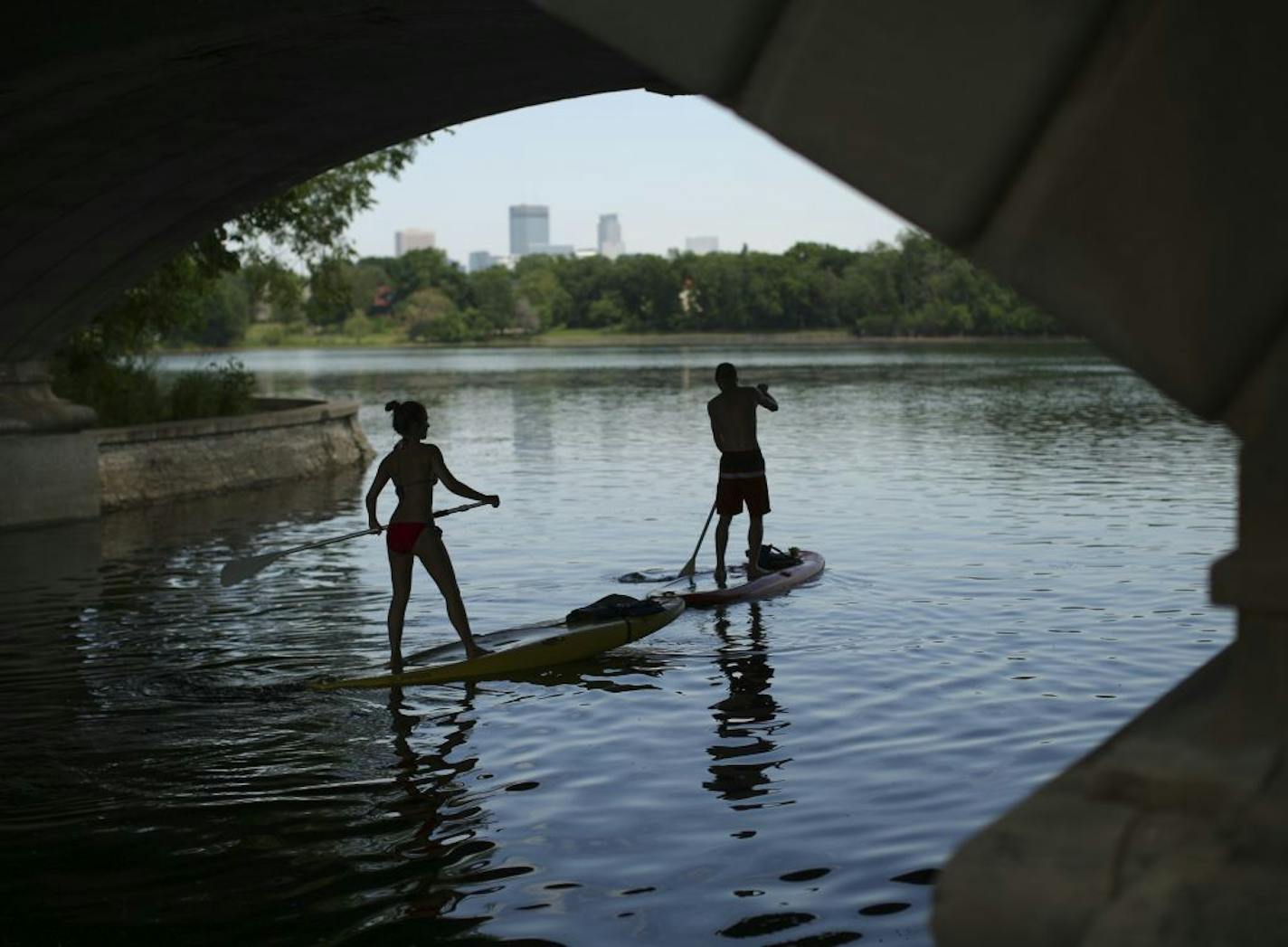 A pair of paddleboarders entered Lake of the Isles from the channel from Cedar Lake, Tuesday, June 9, 2015, in Minneapolis.