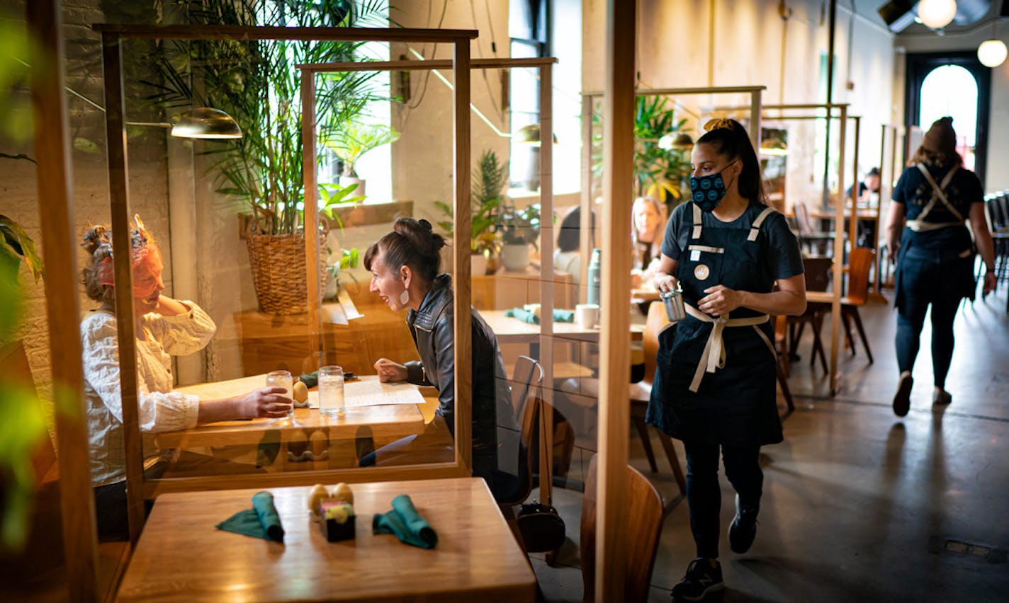 Anna Botz and Jessica Mealey were some of the first customers through the door Wednesday as Hope Breakfast Bar in St. Paul. Owners Brian and Sarah Ingram installed partitions between booths.