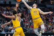 Gophers guard Cam Christie, left, and forward Parker Fox (23) defend Michigan State's A.J. Hoggard during the Big Ten tournament at Target Center. The