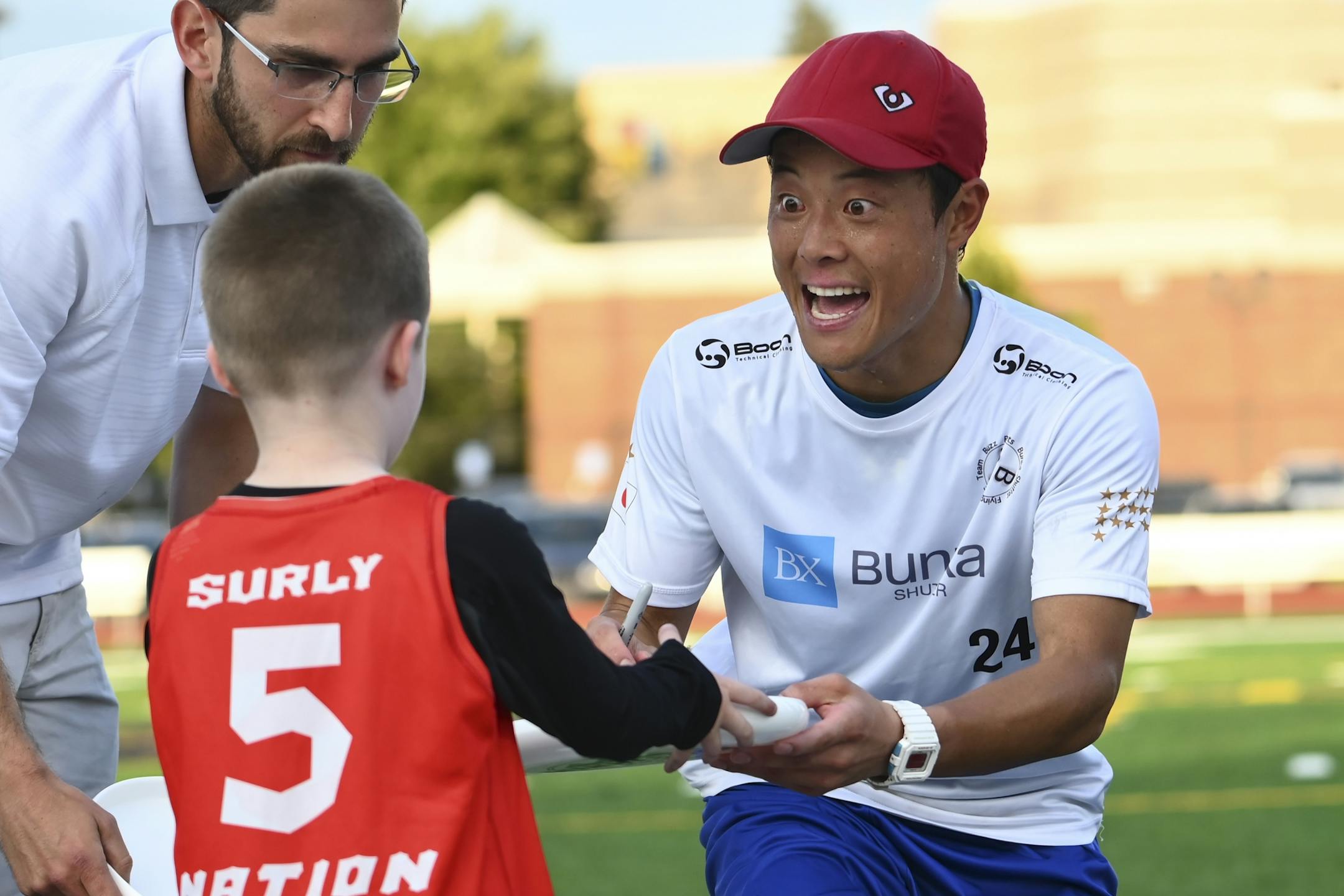 The Buzz Bullet's game MVP, Keiichero Shiba, signed his autograph on a frisbee for Henrik Owens, 4, son of former assistant coach Todd Owens.