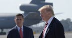President Donald Trump passes National Security Adviser Michael Flynn as he arrives via Air Force One at MacDill Air Force Base in Tampa, Fla., Monday