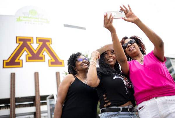 From left, friends Jackie Brown, from Illinois, LaNita Catchings, of Dallas and Angela Primer, of Chicago, take a selfie before a Beyonce concert Thur
