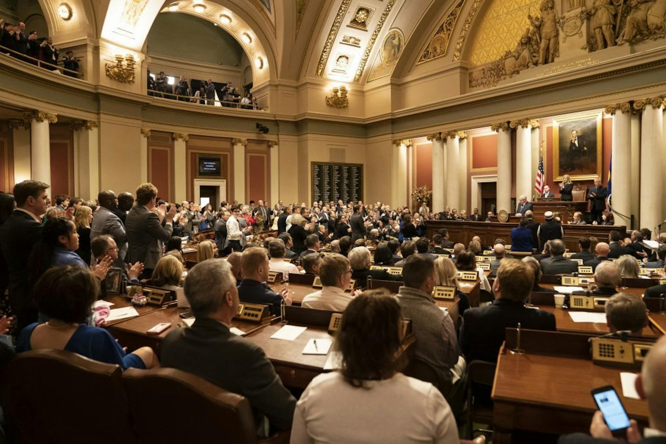 Democrats stood to applaud a statement by Gov. Tim Walz as Republicans stayed in their seats during the State of the State Address at the State Capitol in St. Paul, Minn., on Wednesday, April 3, 2019.