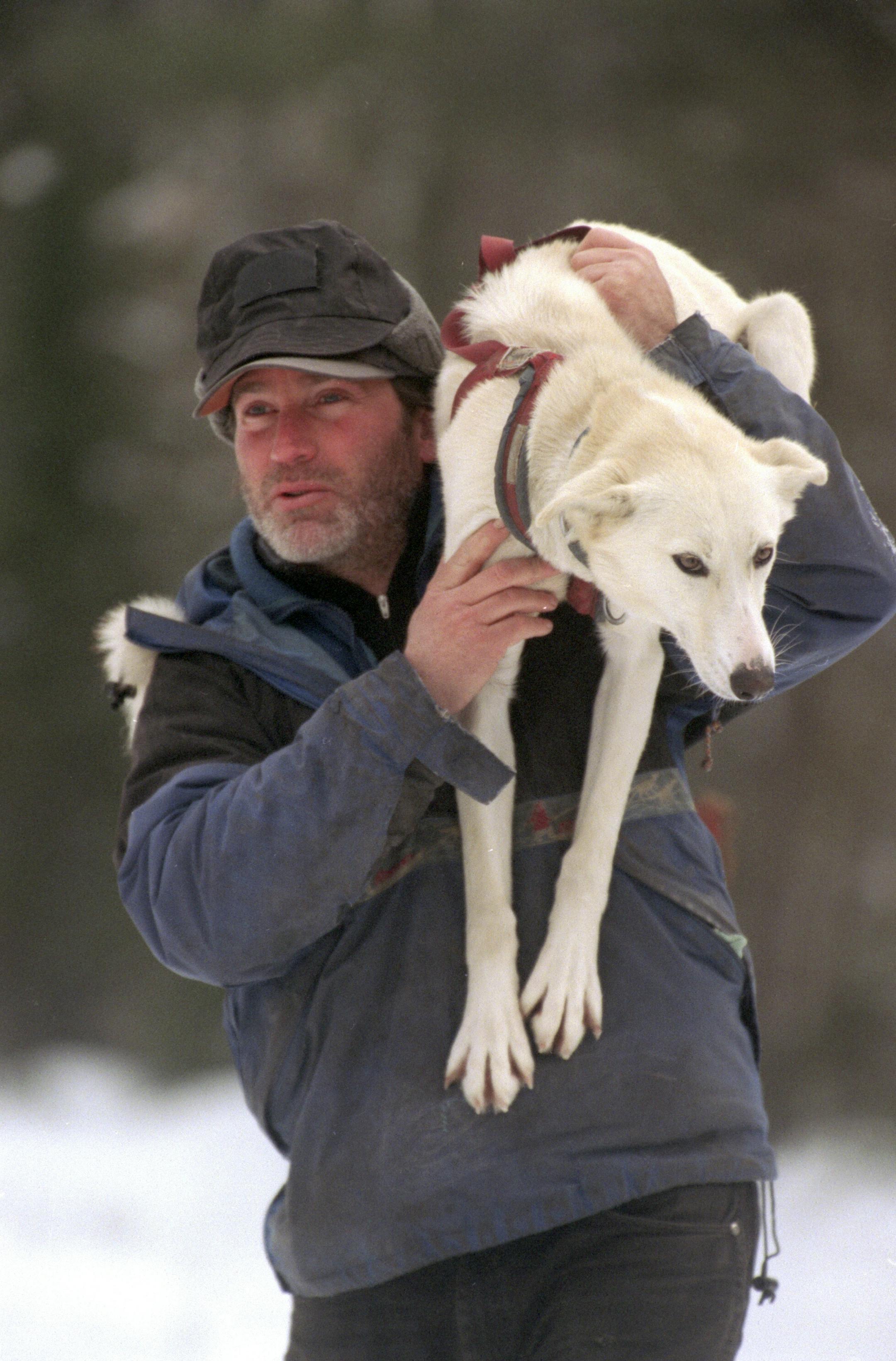 Cliff Wang with one of his mushing dogs. The neuromonics treatment has enabled Wang to live with the sound he describes as "a splitting sea noise."