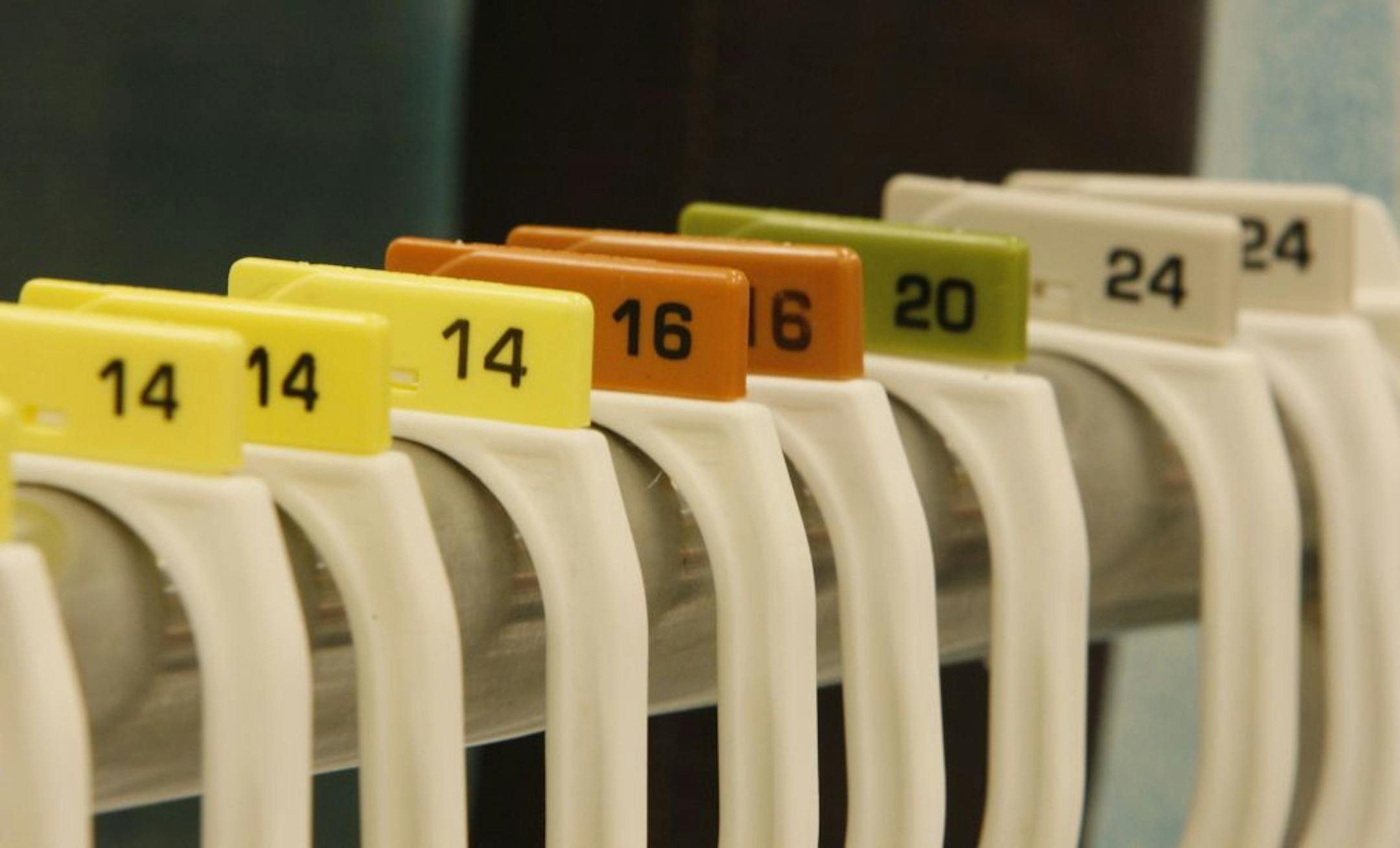 This photo taken Aug. 18, 2009 shows hangers showing sizes for plus size clothing at a Target store in Aventura. Plus size brands are aiming to create sexy and sleek designs like never before, but customers are not buying clothes at the rate they used to.