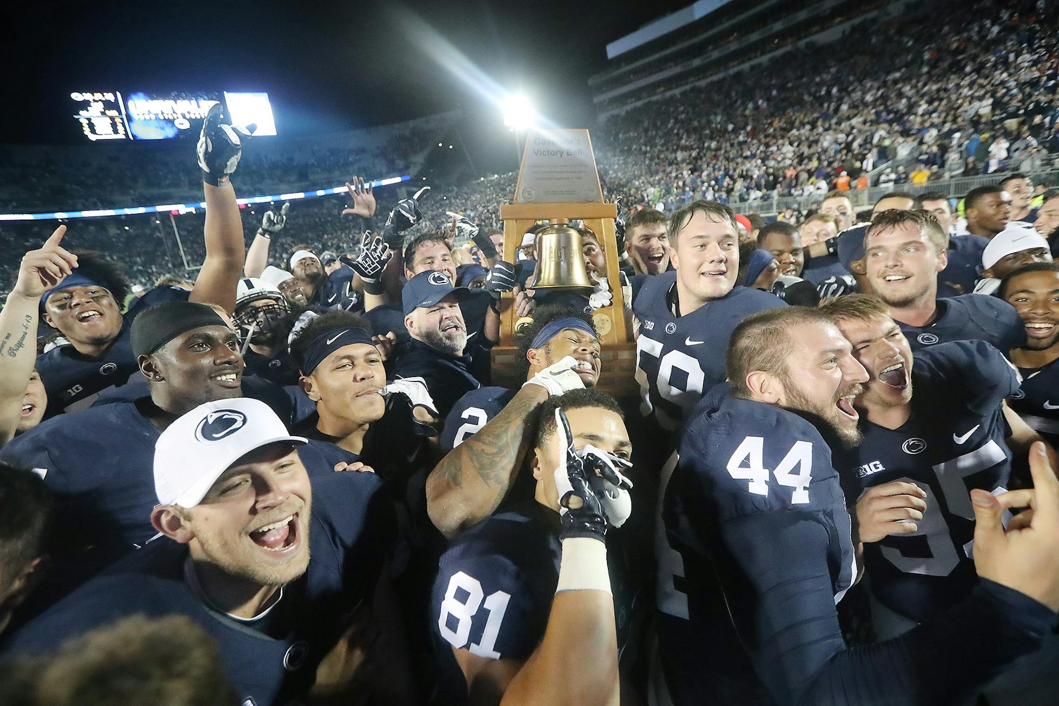 Penn State players celebrated their 29-23 overtime victory over Minnesota with the Governor's Victory Bell on the field at Beaver Stadium, Saturday, October 1, 2016 in State College, PA.