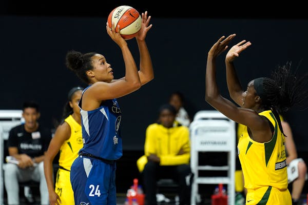 Minnesota Lynx forward Napheesa Collier (24) shoots in front of Seattle Storm center Ezi Magbegor (13) during the first half of Game 3 of a WNBA baske