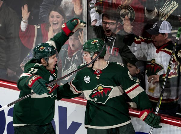 Zach Parise and Ryan Donato celebrated an overtime goal by Donato.