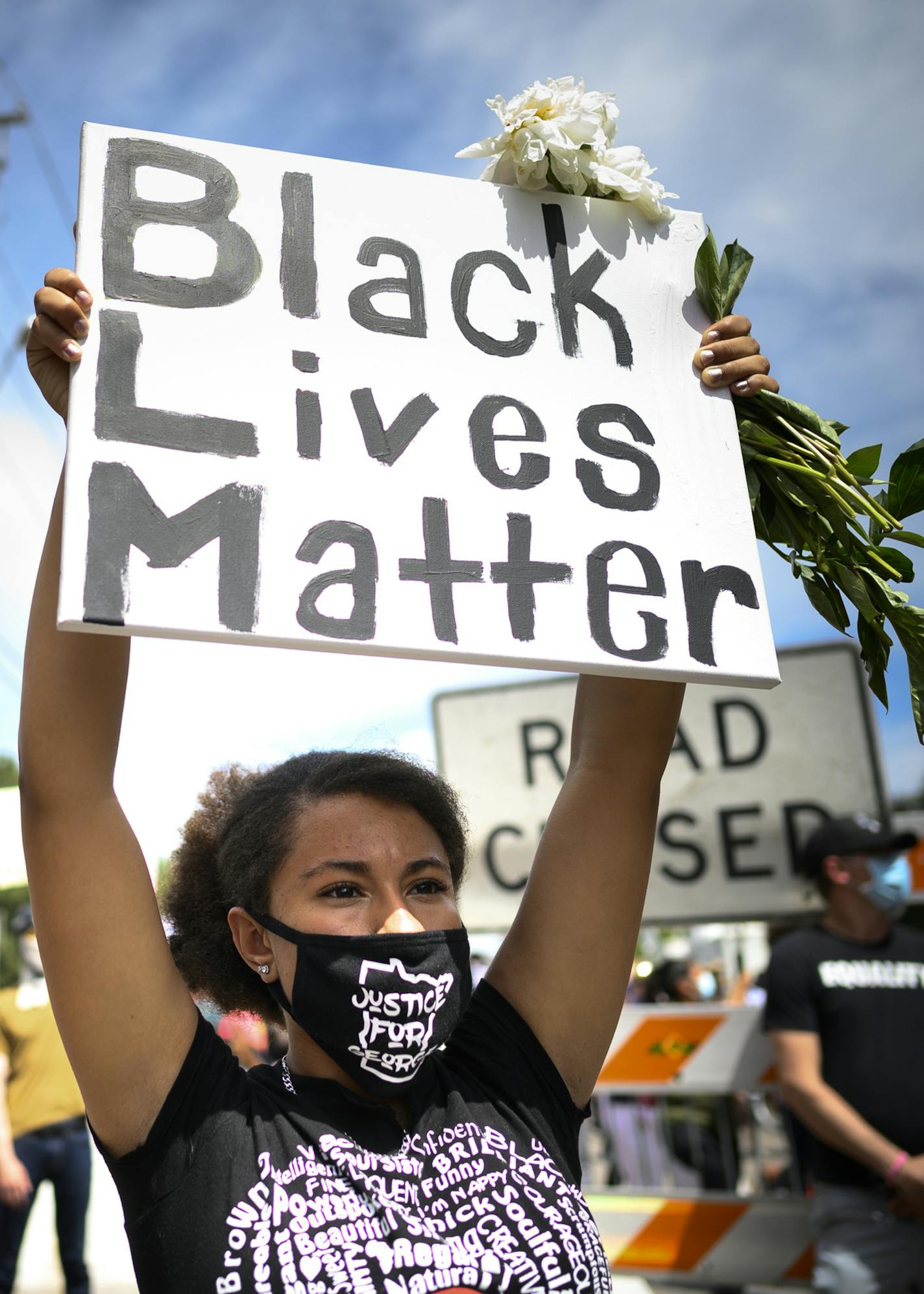 Trinity Dunlap, 15, of Maple Grove, held a Black Lives Matter sign over her head as she listened to Thursday's private memorial for George Floyd downtown. She says she wants to see justice and the abolishment and reformation of police. ] aaron.lavinsky@startribune.com Mourners gathered outside the Frank J. Lindquist Sanctuary at North Central University for a private memorial service for George Floyd, killed in Minneapolis Police custody last week, on Thursday, June 4, 2020 in Minneapolis, Minn.