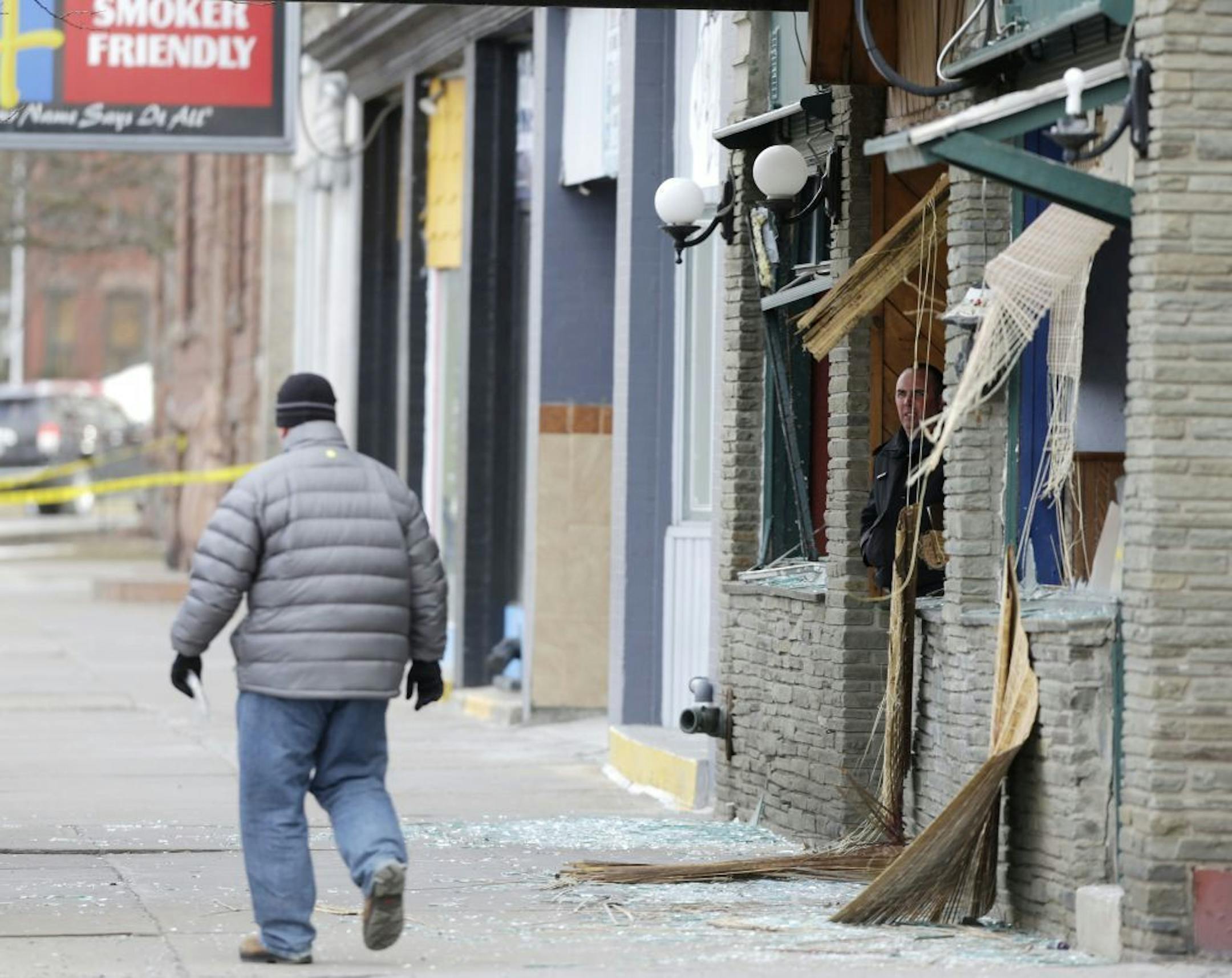 Law enforcement officials work at the building where a man was killed after police stormed it following a standoff on, Thursday, March 14, 2013, in Herkimer, N.Y. The man was suspected of two shootings on Wednesday that killed four and injured two others.