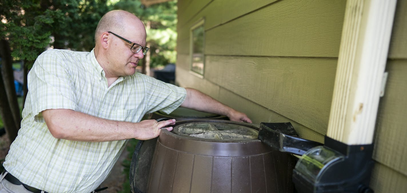 Paul Gardner shows his rain barrels and how they collect rain water. ] LEILA NAVIDI &#x2022; leila.navidi@startribune.com BACKGROUND INFORMATION: Shoreview resident Paul Gardner's family uses just 60 gallons of water a day compared to 300 for the average family of four. Gardner shows off some of his water saving methods in his home in Shoreview on Thursday, August 1, 2019.